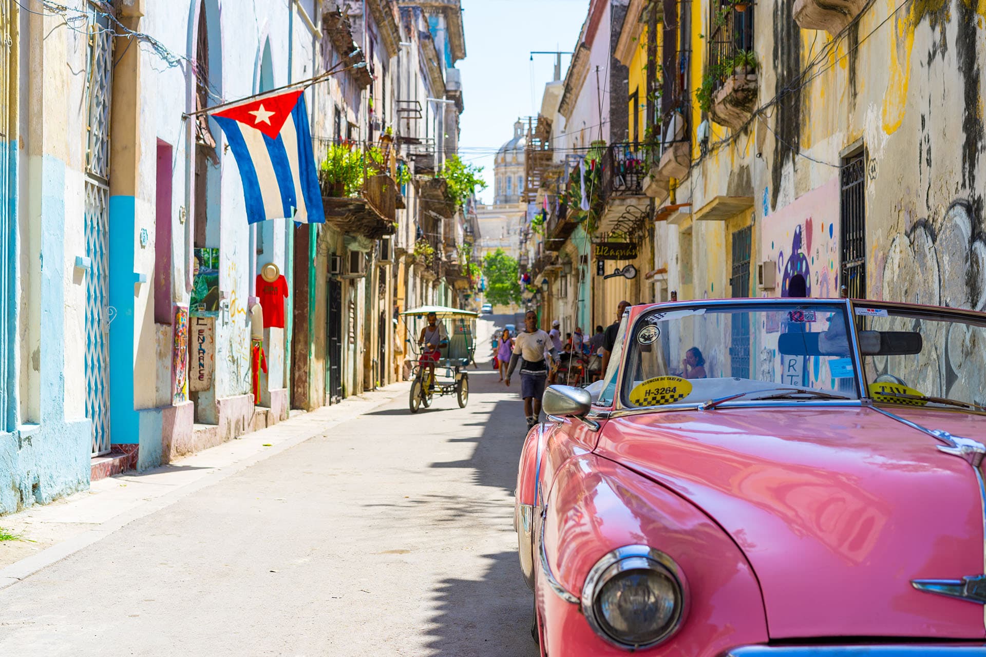 Collage of Cuban landscapes, classic cars, and culture