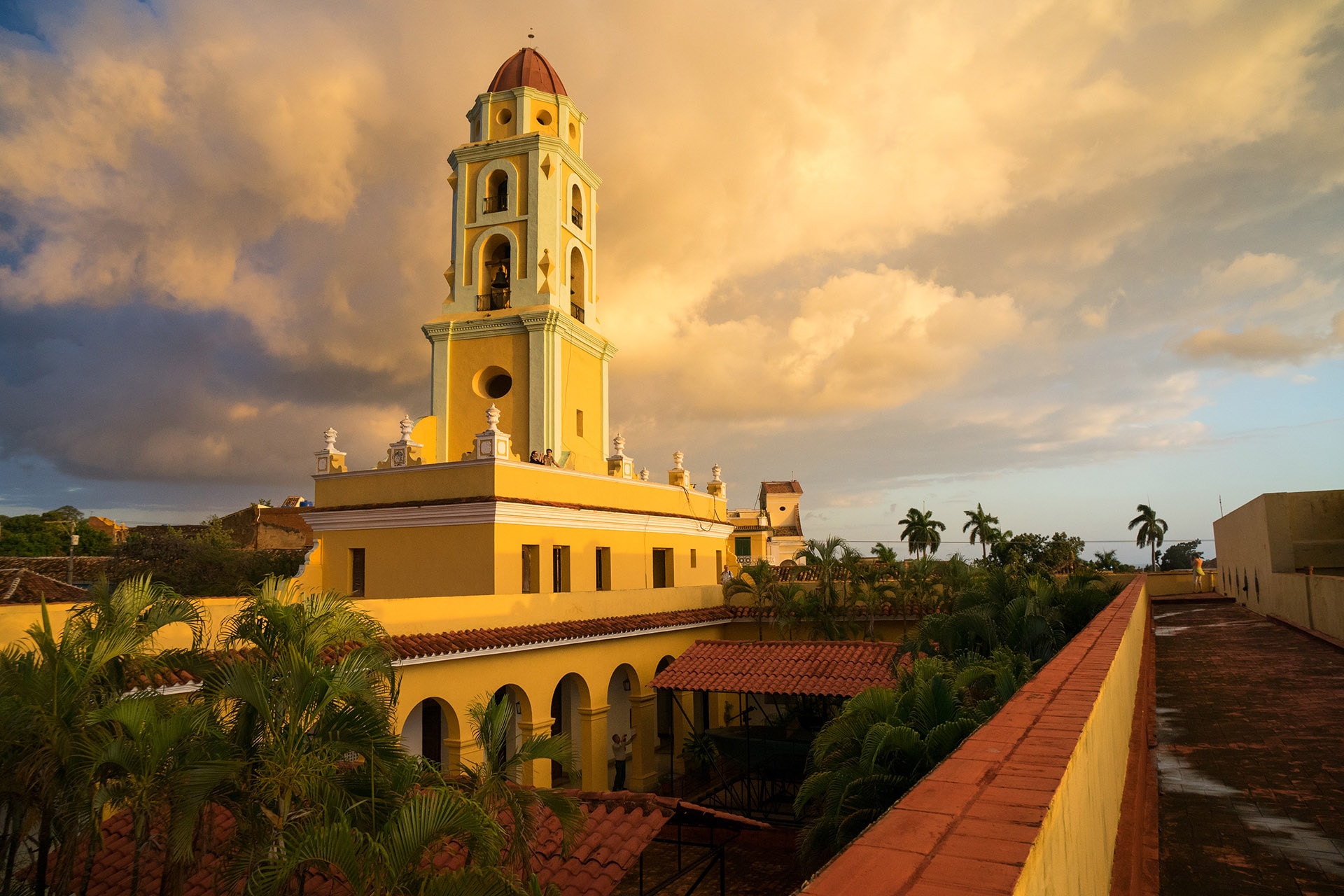 Collage of Cuban landscapes, classic cars, and culture