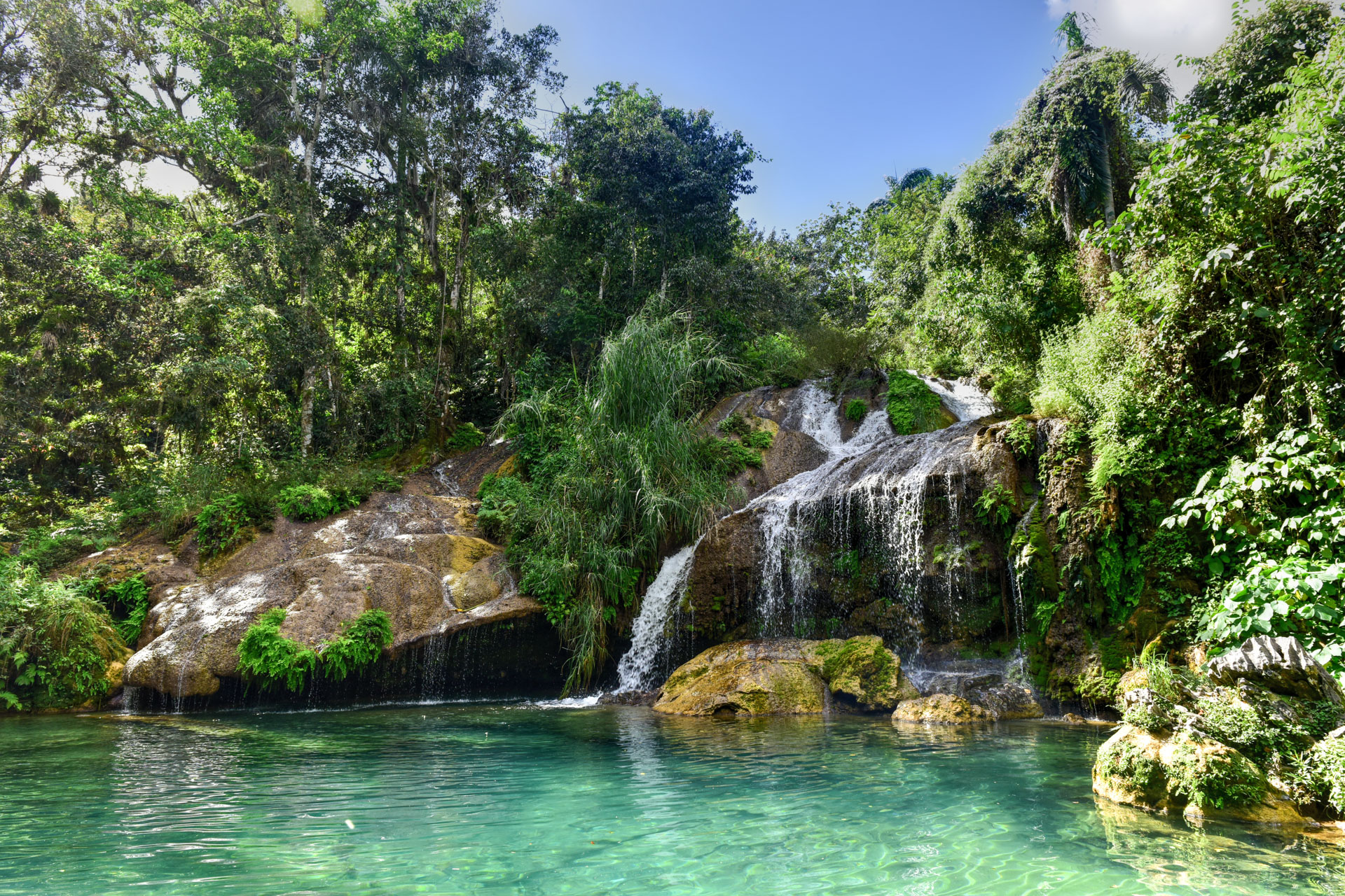 El Nicho Waterfalls in Cuba. El Nicho is located inside the Gran Parque Natural Topes de Collantes, a forested park that extends across the Sierra Escambray mountain range in central Cuba.